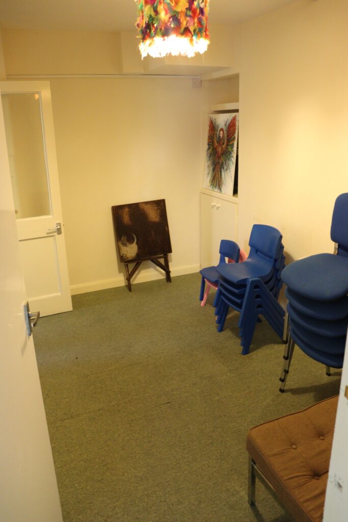 Inner room showing stacked children sized chairs ready for use.
